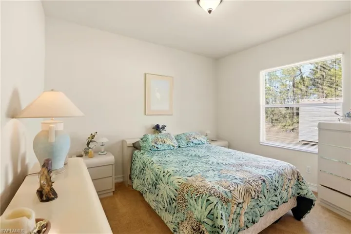 Bedroom featuring carpet and baseboards