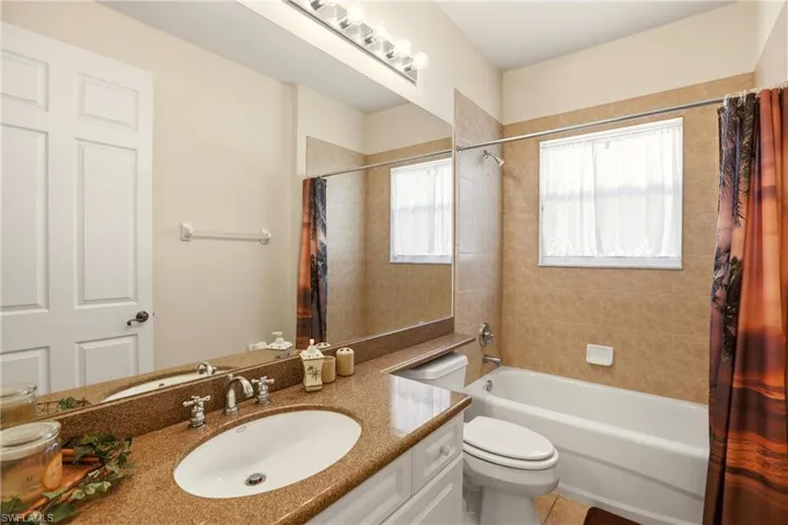 Full bath featuring shower / tub combo and vanity
