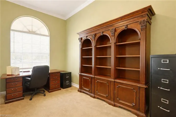 Office featuring light carpet and ornamental molding