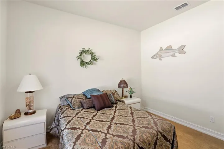 Bedroom featuring carpet floors and baseboards