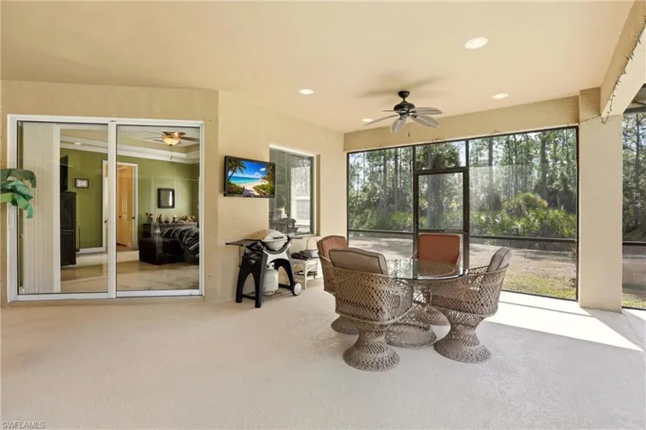 Sunroom / solarium with ceiling fan and outdoor dining area