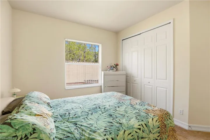Bedroom featuring carpet flooring and a closet