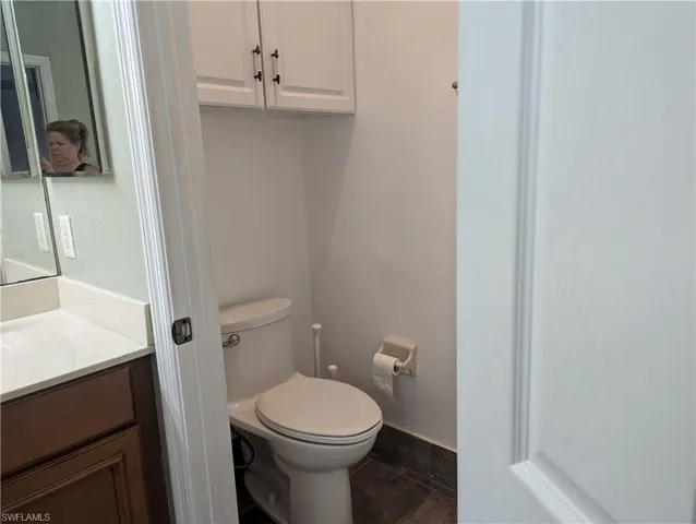 Bathroom featuring tile flooring, toilet, and vanity