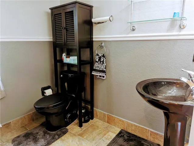 1st floor Bathroom featuring toilet and tile floors