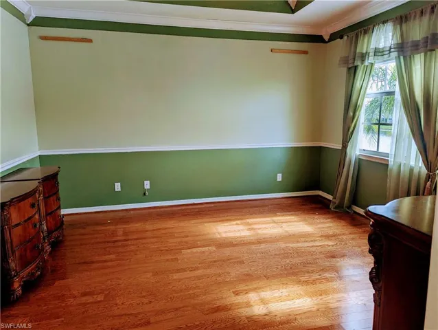 Master Bedroom room with wood-type flooring and ornamental molding