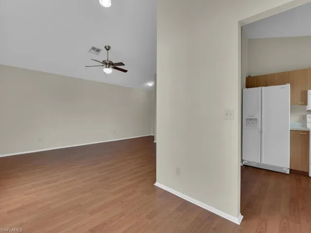 Unfurnished living room with ceiling fan and light hardwood / wood-style floors