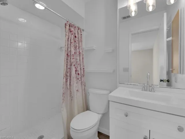 Bathroom with vanity, toilet, and walk in shower