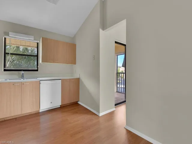 Kitchen with sink, light wood-type flooring, dishwasher, and light brown cabinets