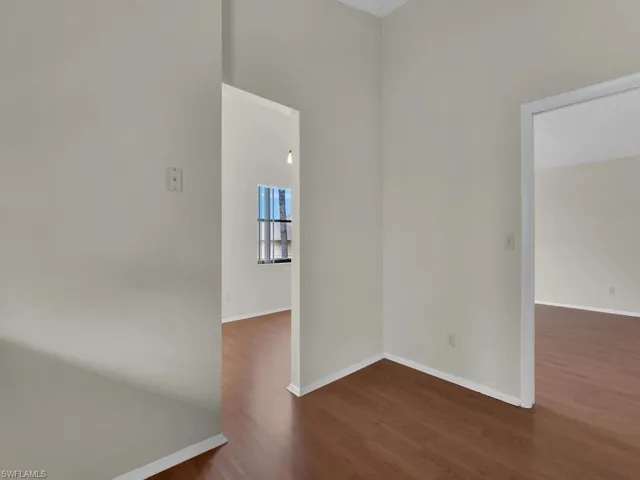 Unfurnished room featuring dark wood-type flooring