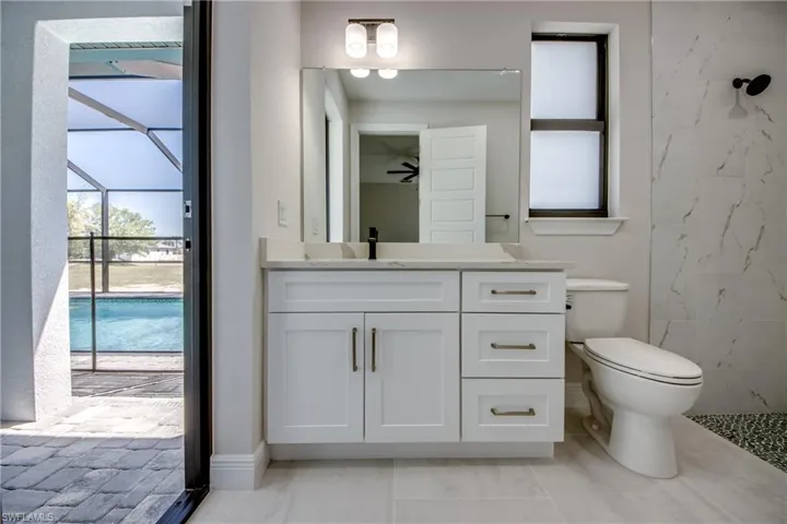 Full bathroom featuring a ceiling fan, toilet, and vanity