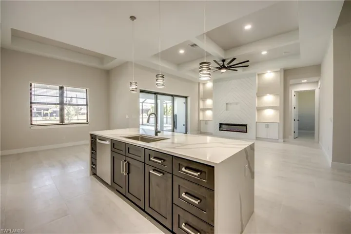 Kitchen with open floor plan, a sink, plenty of natural light, and ceiling fan