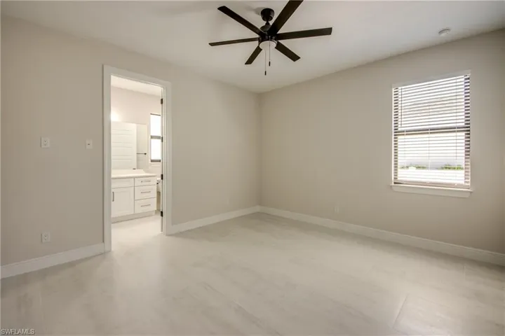 Spare room featuring baseboards and ceiling fan