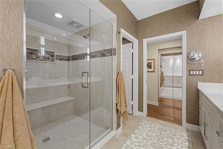 Full bath featuring a stall shower, vanity, light tile patterned floors, recessed lighting, and a closet