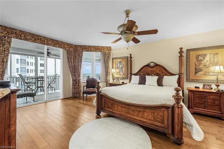 Bedroom featuring wood finished floors, ornamental molding, access to exterior, and a ceiling fan