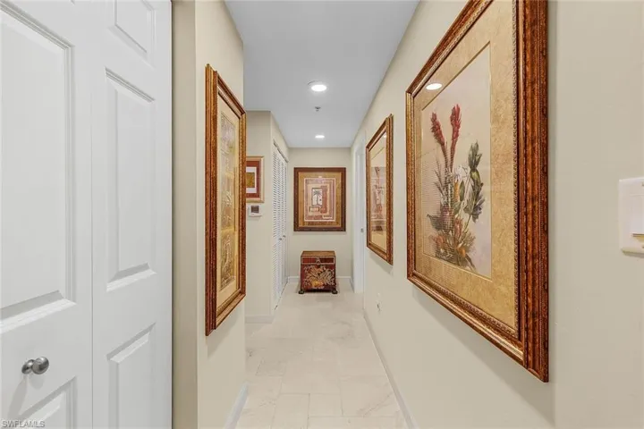 Hall with baseboards and recessed lighting