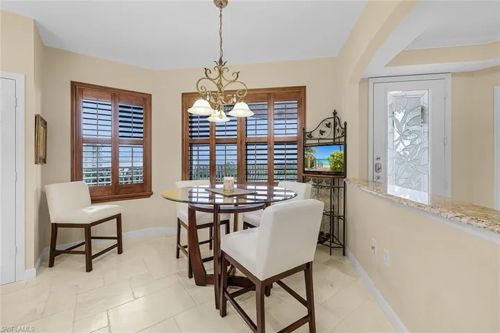 Dining space with a chandelier and baseboards