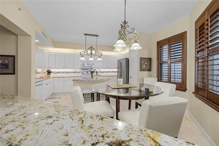 Dining room featuring a chandelier and light tile patterned floors