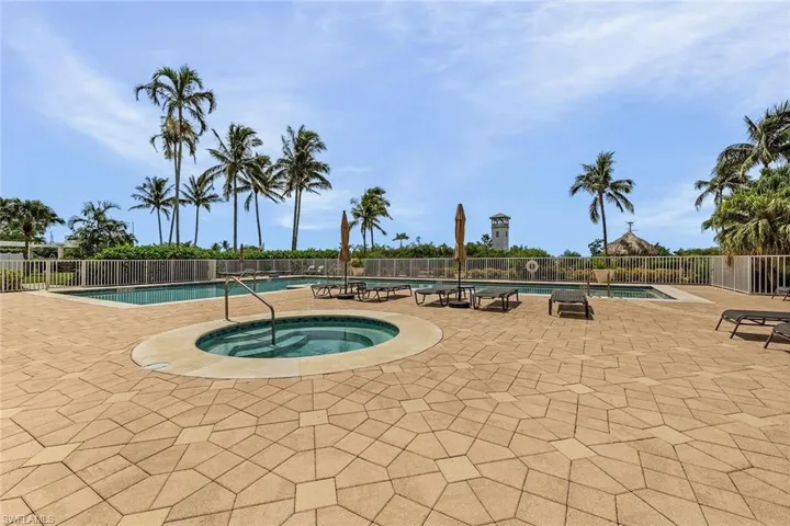 Community pool with a hot tub and a patio area