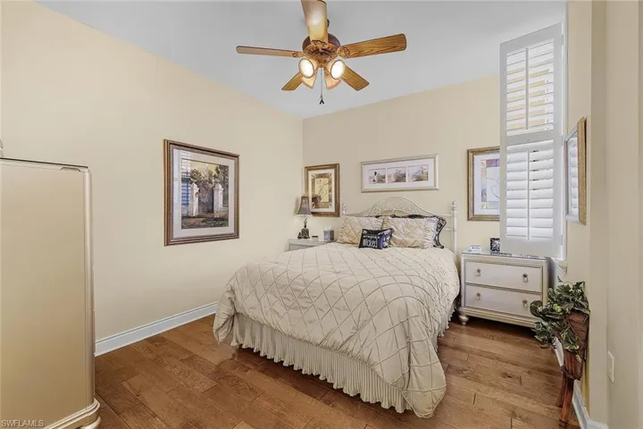 Bedroom with wood-type flooring and ceiling fan