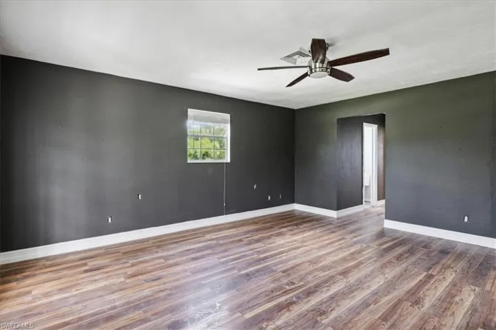 Spare room with wood-type flooring and ceiling fan
