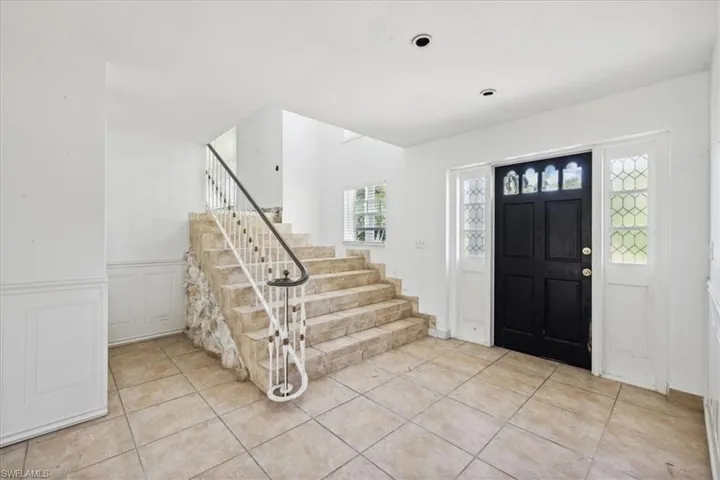 Entrance foyer featuring light tile patterned flooring