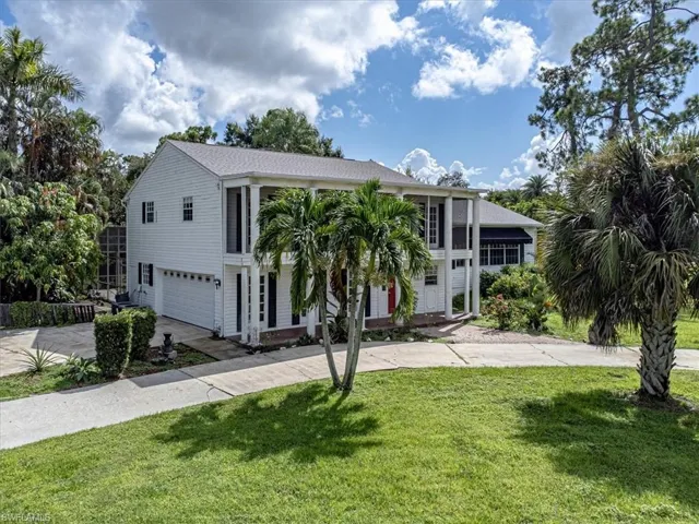 View of front of house featuring a garage and a front yard