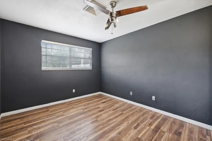 Empty room featuring hardwood / wood-style floors and ceiling fan