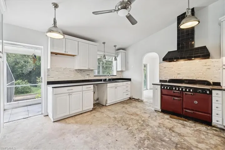Kitchen with white cabinets, backsplash