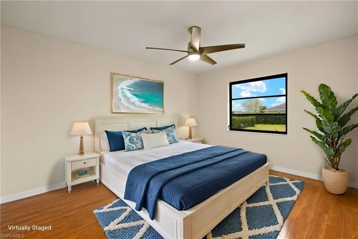 Bedroom featuring wood finished floors and ceiling fan