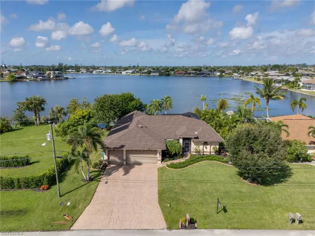 Aerial view of property and surrounding area featuring a large body of water