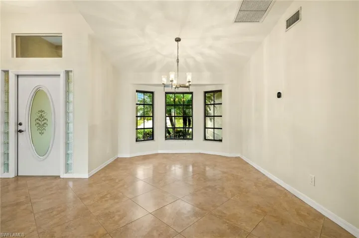 Entryway featuring a chandelier and tile patterned flooring