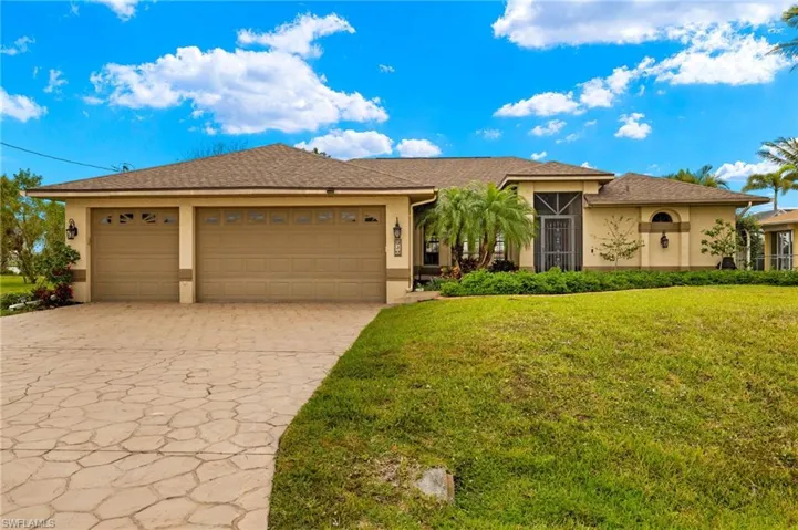 Single story home with stucco siding, decorative driveway, a front yard, a garage, and a shingled roof