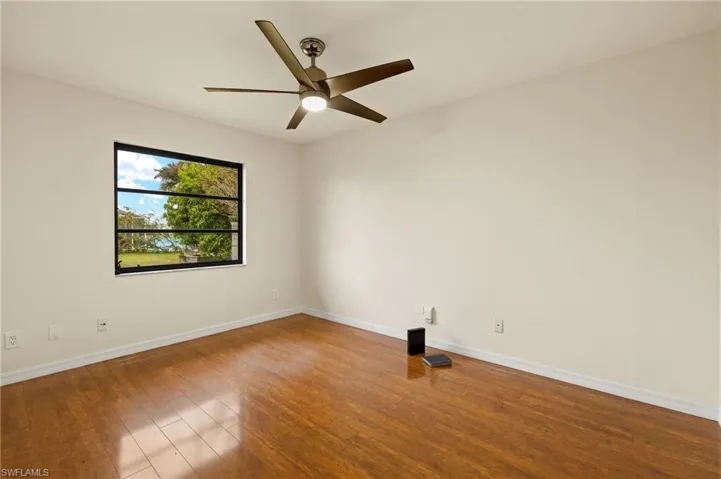 Empty room featuring wood finished floors and ceiling fan