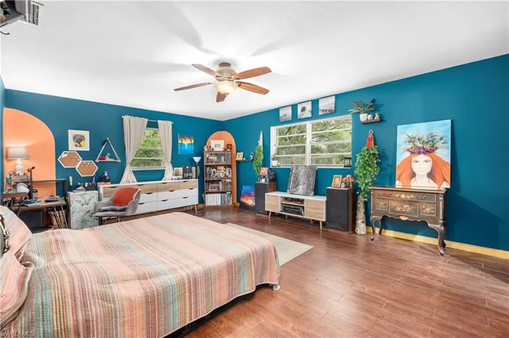 Bedroom featuring ceiling fan and wood-type flooring