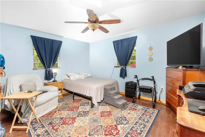 Bedroom featuring hardwood / wood-style flooring and ceiling fan