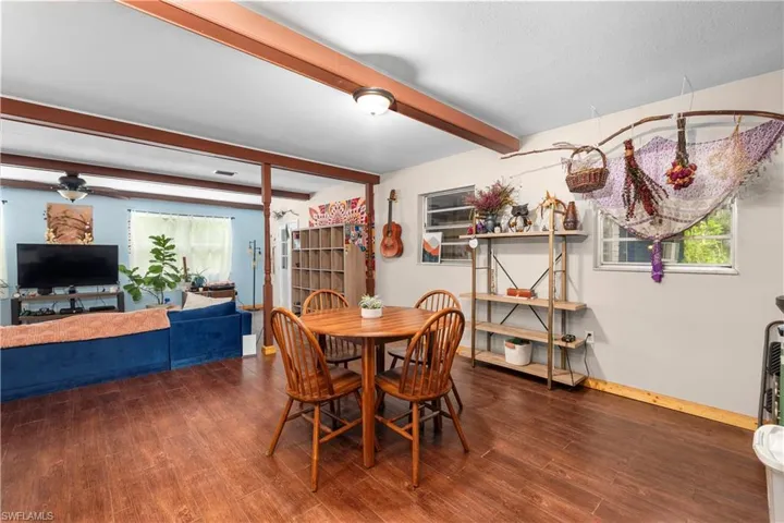 Dining area with beamed ceiling and hardwood / wood-style floors