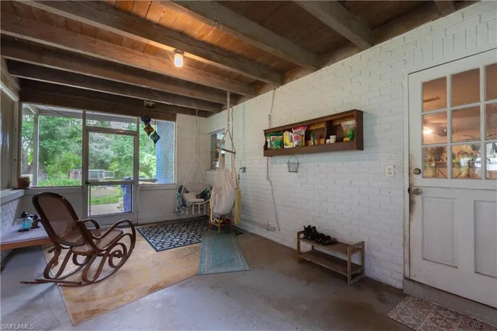 Sunroom / solarium with beamed ceiling and wooden ceiling