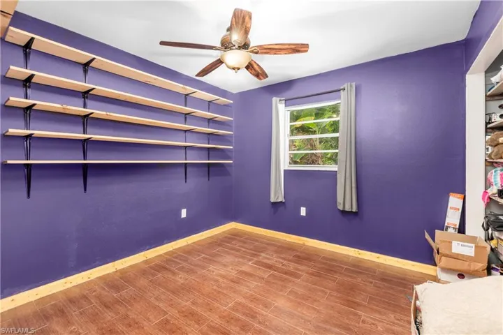 Unfurnished bedroom with hardwood / wood-style floors and ceiling fan
