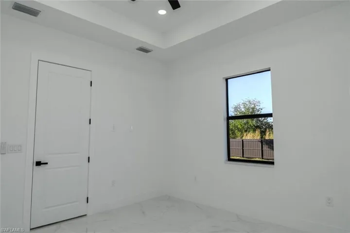 Empty room with light marble finish floors, recessed lighting, and a ceiling fan