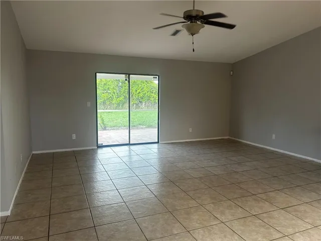 Unfurnished room featuring tile flooring and ceiling fan