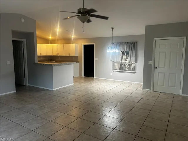 Unfurnished living room with tile flooring and ceiling fan
