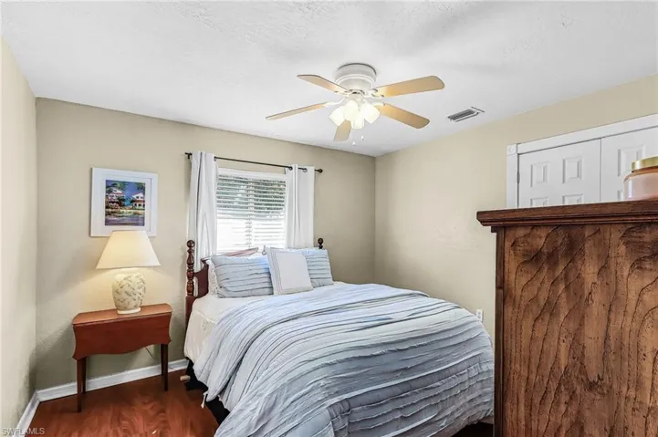 Bedroom featuring wood finished floors, ceiling fan, and a textured ceiling