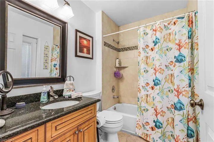 Bathroom featuring vanity and shower / bath combo with shower curtain