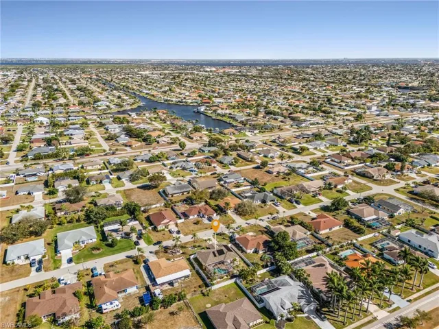 Aerial view of property's location featuring nearby suburban area