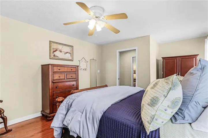 Bedroom with a ceiling fan and wood finished floors