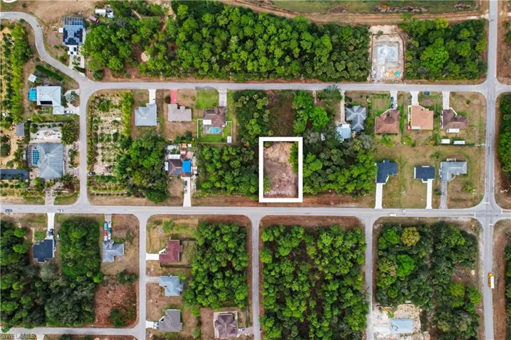 Aerial overview of property's location with property boundaries highlighted and nearby suburban area