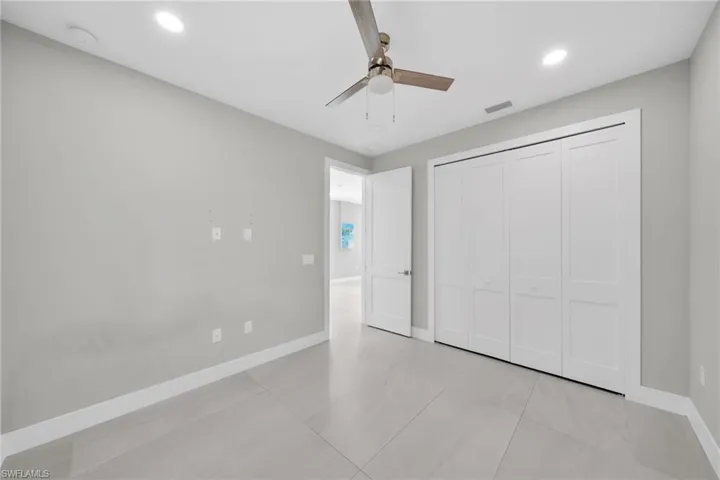 Unfurnished bedroom with a ceiling fan, recessed lighting, and a closet