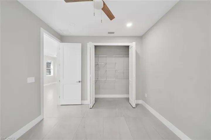 Unfurnished bedroom with a closet, a ceiling fan, and recessed lighting