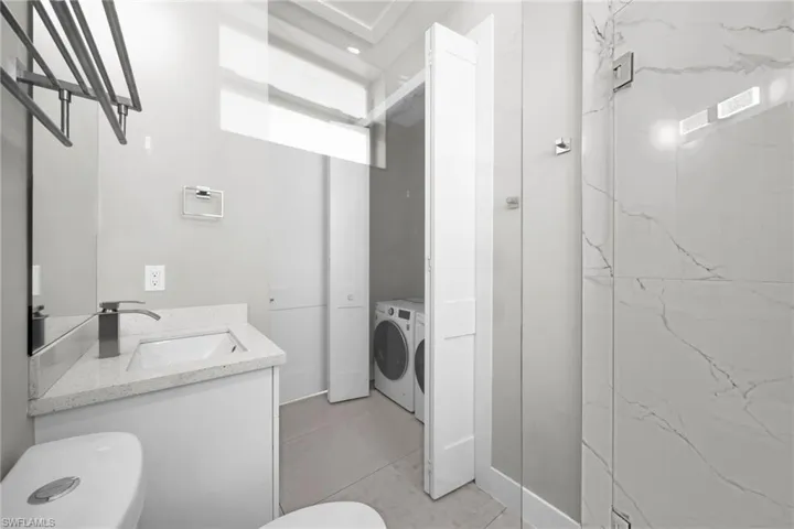 Bathroom featuring vanity and washing machine and dryer