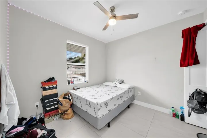 Bedroom featuring ceiling fan and light tile patterned flooring